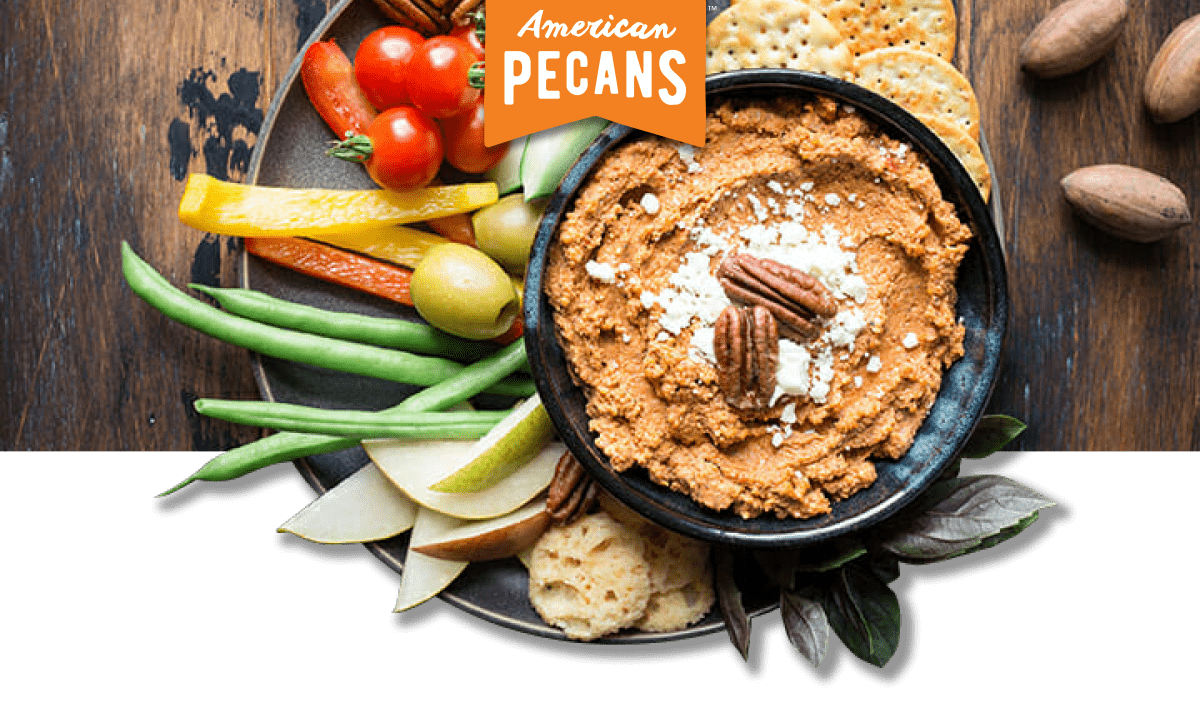 American Pecans logo with plate of roasted red pepper pecan dip and assorted vegetables